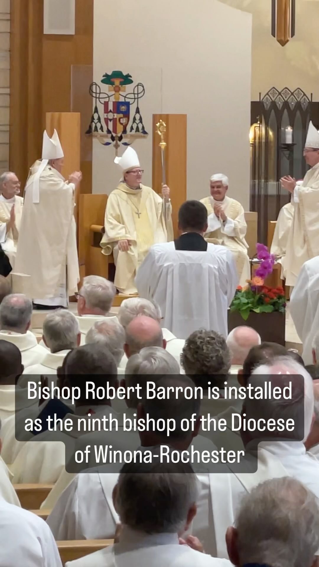 @bishopbarron , well known as the founder of @wordonfire_catholicministries, was installed July 29. Above, the assembly applauds as he receives his crosier. #wordonfirecatholicministries #bishop #bishopinstallation #catholicsofinstagram